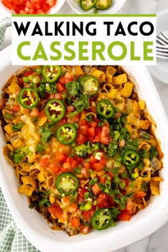 a white casserole dish filled with tortilla shells and vegetables