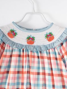 Dress up your little pumpkin in this adorably smocked blue & orange plaid dress! Featuring adorable embroidered pumpkins, this dress is made of soft milk silk for the ultimate comfort! Be the envy of other moms with this sweet & stylish dress! 95% Polyester, 5% Spandex The 'milk silk' feel of the material is a blend of Cotton/Polyester/spandex. The pattern is referred to as "milk silk" a super soft, comfortable, buttery feel material- you will fall in love! Care instructions: Cold wash, gentle c Girls Boutique Dresses, Pumpkin Girl, Plaid Pumpkin, Girls Smocked Dresses, Smocking Patterns, Soft Milk, Girls Smock, Childrens Clothing Boutique, Orange Plaid