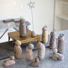 some rocks are sitting on a table and one is made to look like people with crowns