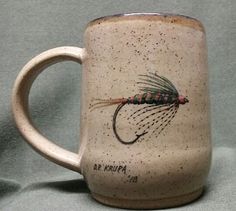 a coffee mug with a fly on it