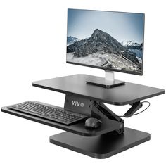 a computer desk with a monitor and keyboard on top of it, in front of a white background