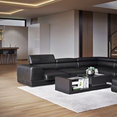 a modern living room with black leather furniture