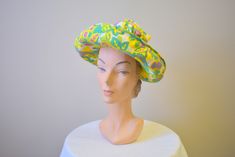 "Vintage 1960s chartreuse/acid yellow straw hat, with printed cotton brim and crown. The crown is gathered at the top and is open on the top. It has an upturned brim. The hat is in good condition -- no holes; it has a few very faint, small spots. The interior circumference is 21\", the brim is 3.25 - 4.5\" wide and the crown is 7\" tall. ---> If you need an order shipped by a particular date or shipped via a quicker method, please ask PRIOR to purchase to see if we can accommodate that reques Retro Green Hat For Vacation, Vintage Cotton Sun Hat With Curved Brim, Vintage Cotton Wide Brim Sun Hat, Retro Spring Sun Hat Cap, Vintage Wide Brim Cotton Sun Hat, Retro Spring Sun Cap, Retro Fitted Hats For Spring, Retro Fitted Hat For Spring, Retro Summer Sun Hat