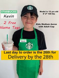 a young boy wearing an apron and holding a starbucks drink