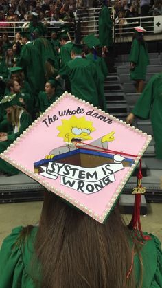 a person wearing a graduation cap with the simpsons on it