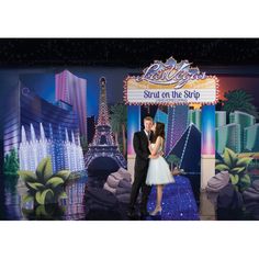 a man and woman standing in front of a sign for las vegas nights 2011 on stage