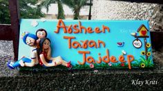 there is a sign that says ayeen toan jader on it and two people sitting on the sign