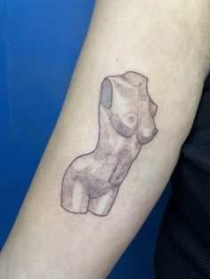 a woman's arm with a small tattoo of a dog on the left forearm