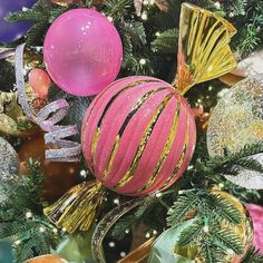 pink and gold ornaments on a christmas tree