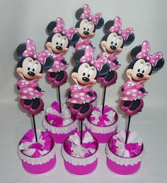 minnie mouse cupcakes with pink and white polka dots on them are arranged in rows