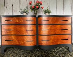 two vases with flowers sit on top of an old dresser that has been turned into a sideboard