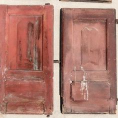 two old wooden doors with peeling paint on the outside and inside, one is red