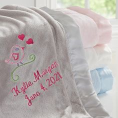 the personalized blanket is on display in front of some folded towels and blankets with hearts