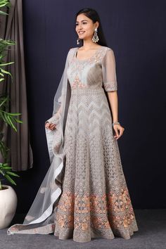 Add vibrant grace and colors to your festive wardrobe with this designer grey embroidered net anarkali with skirt with lace work on it. A fully embroidery work on anarkali suit with heacy dupatta makes this a sophisticated piece of luxury that will captivate you in its calmness and serenity. Style this set with a pair of diamond earrings and solid pumps to finish the look from Pure Elegance. Disclaimer: The actual product may vary slightly from the image. These are custom orders, hence expect slight variation in color, placement of the motif or buta. ESTIMATED DELIVERYBecause this is a custom order, it would take about 4 weeks from the date of purchase. RETURN POLICYThis product is a custom order and cannot be returned or exchanged. Gray Anarkali Set With Zari Work, Gray Anarkali Set With Dupatta, Festive Floor-length Net Anarkali Set, Semi-stitched Floor-length Net Salwar Kameez, Festive Gray Dupatta With Resham Embroidery, Bollywood Style Gray Dupatta, Designer Gray Dupatta With Zari Work, Anarkali Set With Dabka Work, Gray Zari Work Dupatta For Eid