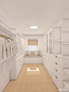 an empty white closet with clothes hanging on the walls and drawers in front of it