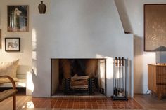 a living room filled with furniture and a fire place