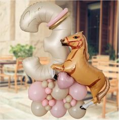 an inflatable horse and pony are on top of balloons