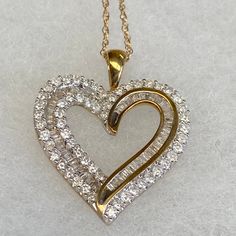 Up for sale is this vintage estate 10 karat solid yellow gold baguettes and round diamond heart 18" necklace, never used w/original boxes and tag.  The necklace chain is a delicate pendant chain measuring 18" long.  The heart pendant features round bezel set diamonds and baguette channel set diamonds set into the heart design (diamonds have been tested genuine).  The attached tag reads 1CTTW AA6/7 10KYG BAG&RD HRT P. The pendant measures 7/8" wide by 1" high.  The reverse of the pendant is marke Yellow Gold Jewelry With Baguette Diamonds For Gift, Yellow Gold Jewelry With Baguette Diamonds As A Gift, Vintage Diamond Heart Pendant Jewelry, Vintage Yellow Gold Jewelry With Baguette Diamonds, Vintage Jewelry With Baguette Diamonds As A Gift, Vintage Jewelry With Baguette Diamonds For Gift, Hallmarked Diamond Heart Pendant Jewelry, Heart-shaped Baguette Diamond Jewelry For Anniversary, Heart Shaped Baguette Diamond Jewelry For Anniversary