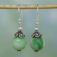 Aventurine stones in an alluring shade of light green dangle attractively in these earrings designed by Narayannii of India. Above and beneath the gemstones, dot motifs adorn handcrafted sterling silver accents. Bohemian Green Pierced Teardrop Earrings, Bohemian Green Teardrop Pierced Earrings, Green Gemstone Round Bead Earrings, Green Gemstone Earrings With Round Beads, Bohemian Jade Gemstone Earrings, Jade Gemstone Drop Earrings, Green Jade Earrings With Natural Stones, Green Jade Earrings For Pierced Ears, Elegant Aventurine Dangle Earrings