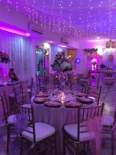 a banquet room set up with purple lighting