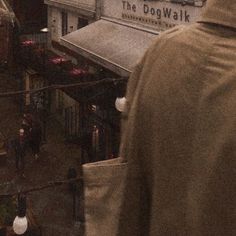 the back of a man's head as he walks past a dog walk shop