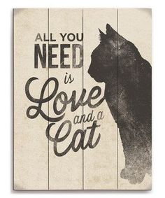 a wooden sign that says, all you need is love and a cat on it