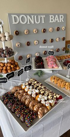 an assortment of donuts on display at a doughnut bar