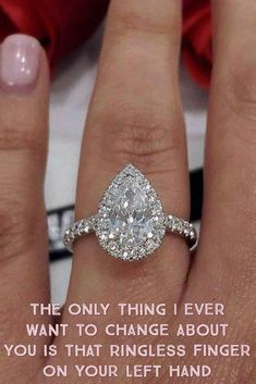 a woman's hand with a diamond ring on it