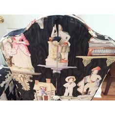 the back of a chair covered in decorative fabric