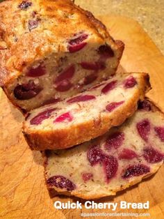 two slices of bread with cranberry toppings on them sitting on a cutting board