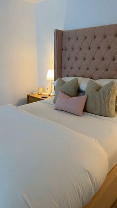 a large bed with two pillows on top of it