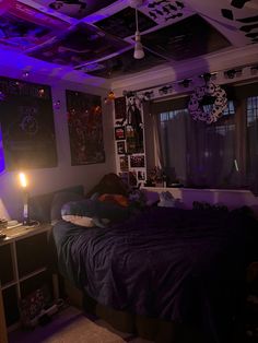 a bedroom with purple lighting and pictures on the wall