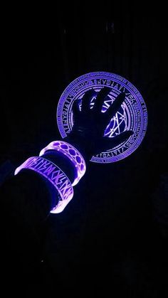 two frisbees lit up in the dark with purple and blue designs on them