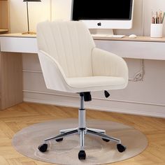 a white office chair sitting in front of a computer monitor