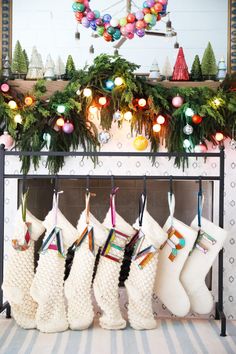 stockings hanging from a fireplace with christmas decorations