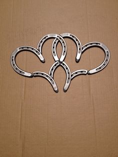 four horseshoes shaped like hearts sitting on top of a cardboard box