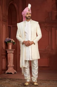 Immerse yourself in the epitome of sophistication with our exquisite ensemble: a cream sherwani paired with a pink turban, a combination that radiates timeless charm and elegance. Crafted from luxurious fabrics such as silk or brocade, the cream sherwani exudes refined opulence with its subtle and intricate detailing. Enhanced with delicate embroidery or embellishments, this sherwani is designed to make a memorable statement at any special occasion, from weddings to cultural celebrations. The pink turban, symbolizing joy and festivity, adds a vibrant yet elegant touch to the attire. Its soft hue harmonizes beautifully with the cream sherwani, creating a cohesive and sophisticated look. Often adorned with intricate patterns or a decorative brooch, the turban elevates the overall ensemble, e Pakistani Suits Party Wear, Wedding Sherwani For Men, Cream Sherwani, Pink Turban, White Dupatta, Sherwani For Men, Bespoke Clothing, Wedding Sherwani, Saree Gown