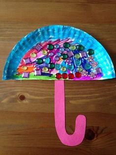 a paper plate umbrella that has been made to look like it is holding candy bars