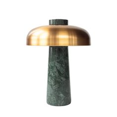 a green marble table lamp with a gold dome light on the top and bottom, against a white background