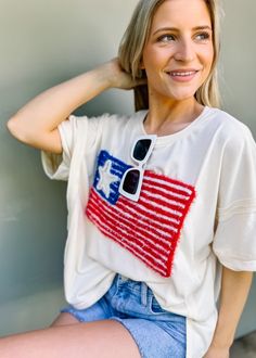 This patriotic tee features a sparkling USA flag embroidery, perfect for Fourth of July celebrations. With a girly and fun touch, it's a must-have for summer outings. Show off your love for America in a unique way with this American Flag Lurex Embroidery Tee. Oversized/ loose fit Round neckline Pull on fit Color: Cream Lurex embroidery Not lined 85% cotton 15% polyester Fabric has little stretch Lurex Embroidery, Patriotic Tees, Flag Embroidery, Floral Dress Casual, Black Short Dress, Dress With Cardigan, Dressy Casual, Casual Blouse, Floral Dress Black