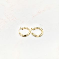 Handcrafted in 14k yellow gold, these hoops are great for everyday wear since they are lightweight. They are plain and can be stacked with other mini hoops or Huggies. They can be worn in the shower, at the gym, and while swimming and do not need to be taken off. They are simple, yet elegant at the same time. These hoops come with a hinged back lock and tube-liked design. 14k hollow yellow gold XXS: Hoop Diameter: 18mm, Thickness: 3mm ﻿﻿All measurements are approximate If you need help picking t The Shower, At The Gym, The Gym, Hinges, Everyday Wear, Swimming, Yellow Gold, Gym, Shower