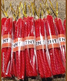 several red candles wrapped in plastic on the ground