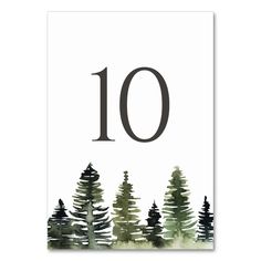 the number ten is surrounded by trees in watercolor on a white card with black ink