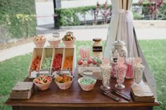 a table topped with lots of candy and candies on top of wooden trays