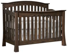 a wooden crib with white bedding and sheets on it's sides, against a white background