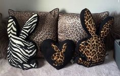 three pillows with animal ears and zebra print on them