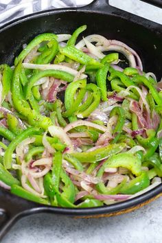 onions and green peppers cooking in a skillet