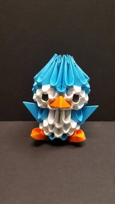 an origami bird sitting on top of a table