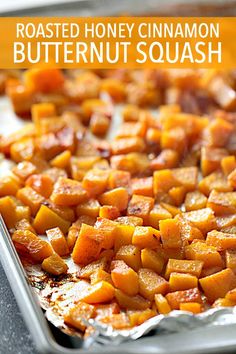 roasted honey cinnamon butternut squash on a baking sheet with text overlay that reads roasted honey cinnamon butternut squash