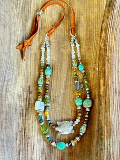 This colorful, double strand, Sundance style beaded necklace is a blend of my favorite colors, blues, yellow, rustic brown and Peridot green. I used tiny freshwater seed Pearls to start it off. Then blended faceted turquoise rounds, Blue and Yellow Chevron beads, a white freshwater Coin Pearl, 4 stunning Kingman Turquoise nuggets, Three natural Peridot nuggets and a ton of Hilltribe Silver! A Hilltribe Silver Turtle is the focal on the first strand. This hangs from Carmel colored very soft , but Chevron Beads, Sundance Jewelry, Sundance Style, Yellow Chevron, Mixed Media Jewelry, Green I, Silver Elephants, Peridot Green, Silver Bead Necklace